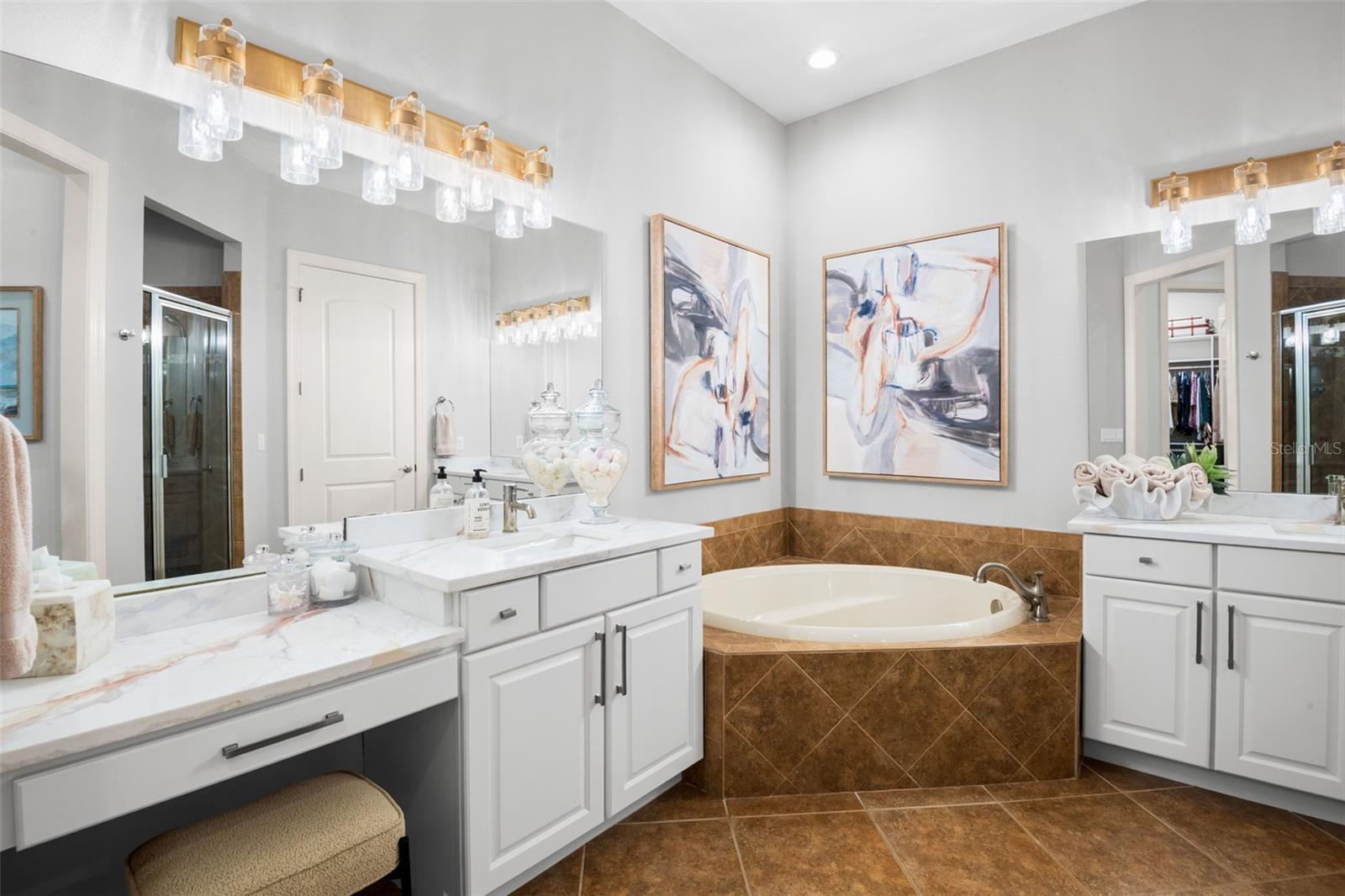 Owner's bath with large, dual vanities, soaking tub, oversized walk-in shower and water closet.