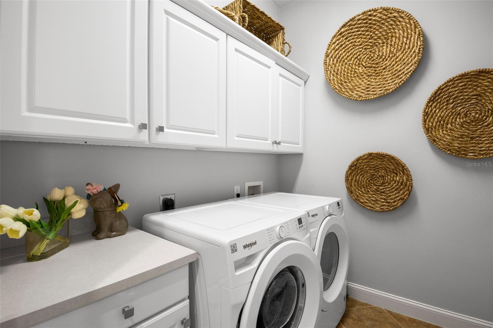 Laundry Room with new washer and dryer together with extra storage space, laundry sink and counter space.