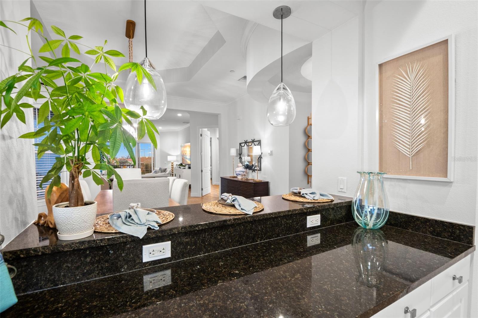 Close up of Kitchen breakfast bar toward Dining Room and Living Room.