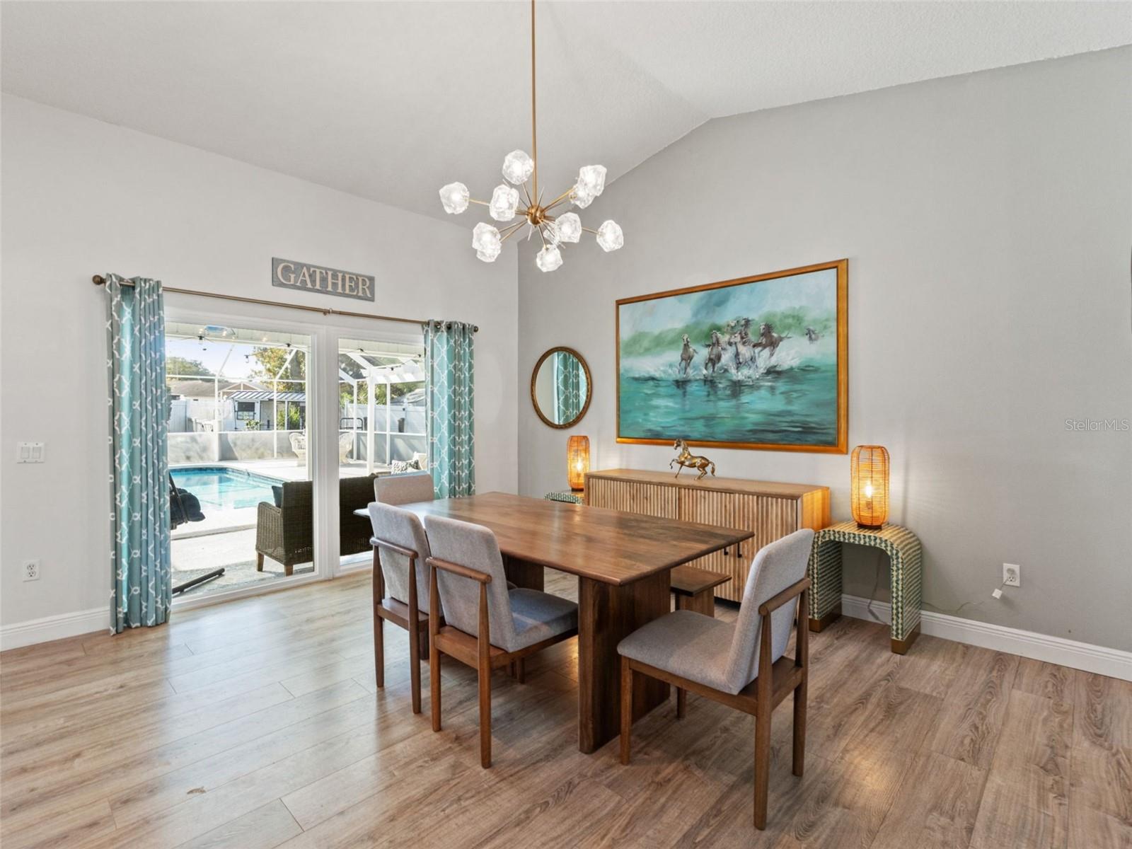 Dining with picture window to pool