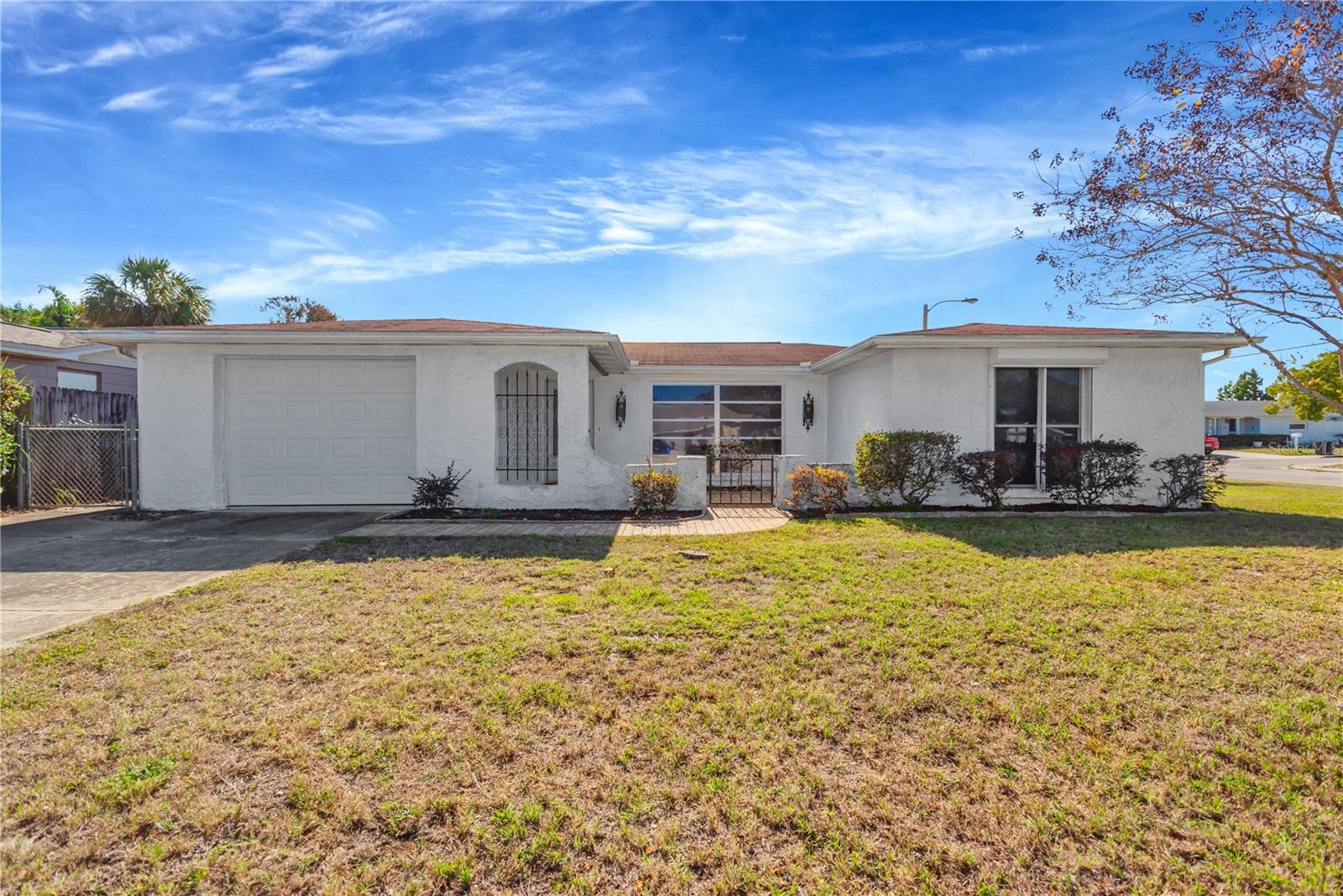 Front elevation showing courtyard area and single car garage