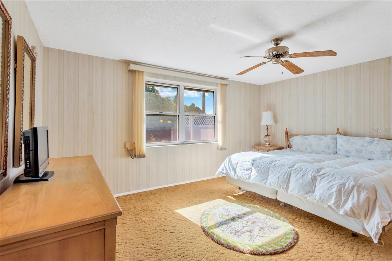 Primary bedroom with view of backyard