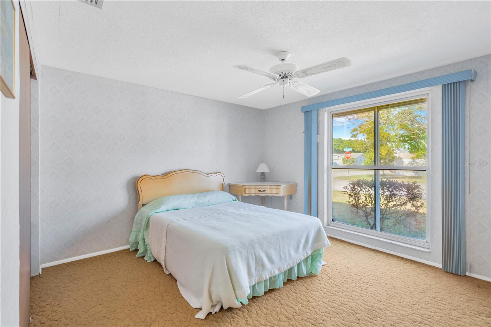 Guest bedroom with view of the front yard