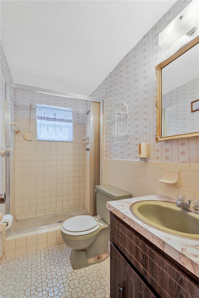 Guest hall bath off of kitchen and garage entry