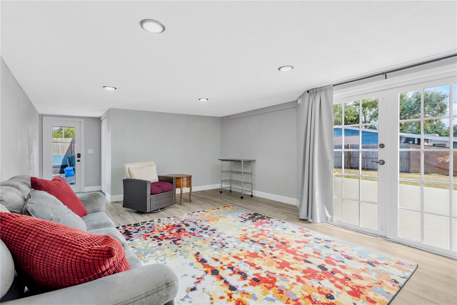 Another view of the bonus room showing French doors leading to the back patio