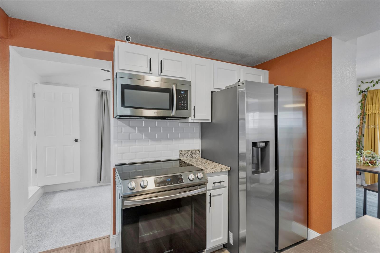 View from Kitchen, den to the left and Dining room to the right