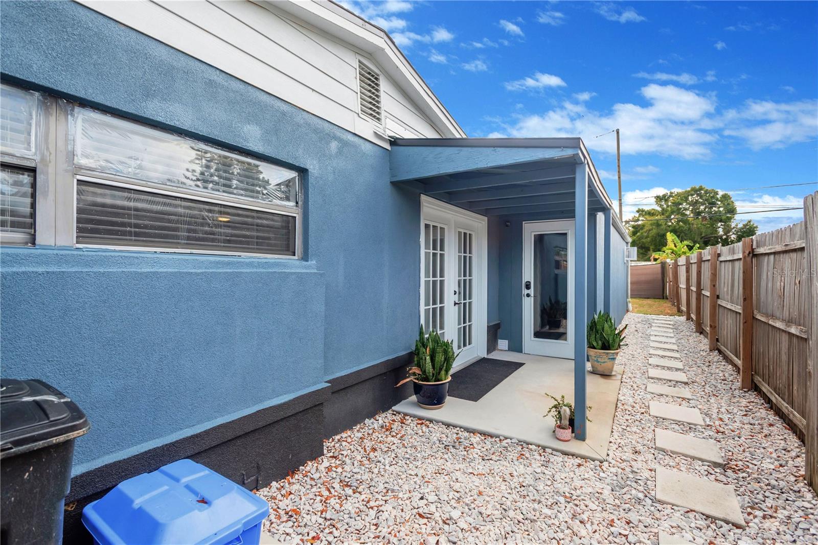 Side yard with French Doors off of the Dining room. Bonus room and laundry area is other door