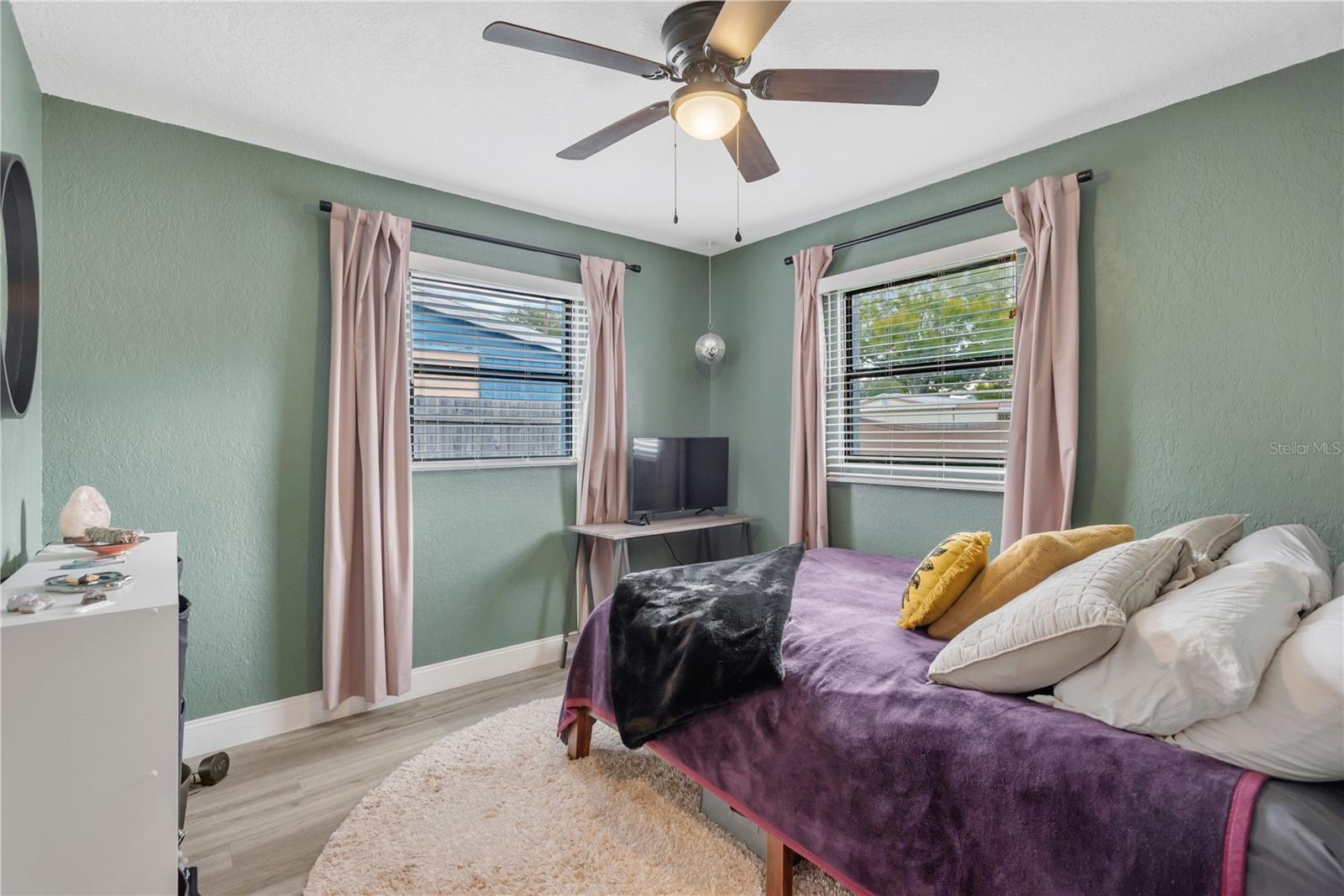 Primary bedroom with views of the back and side yard