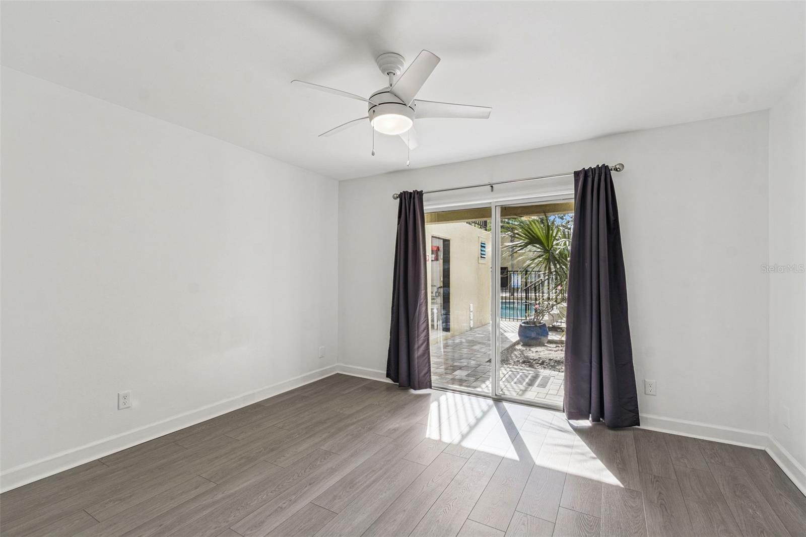 Primary bedroom/ patio doors overlooking pool! Laundry is immediately out to the left!