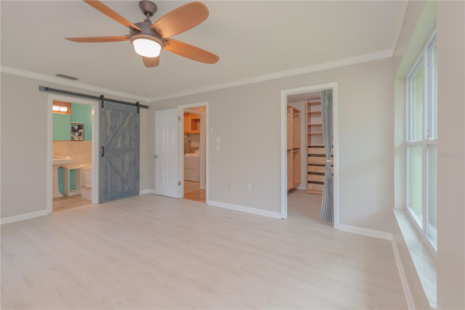 Primary bedroom with walk-in closet and ensuite bathroom.