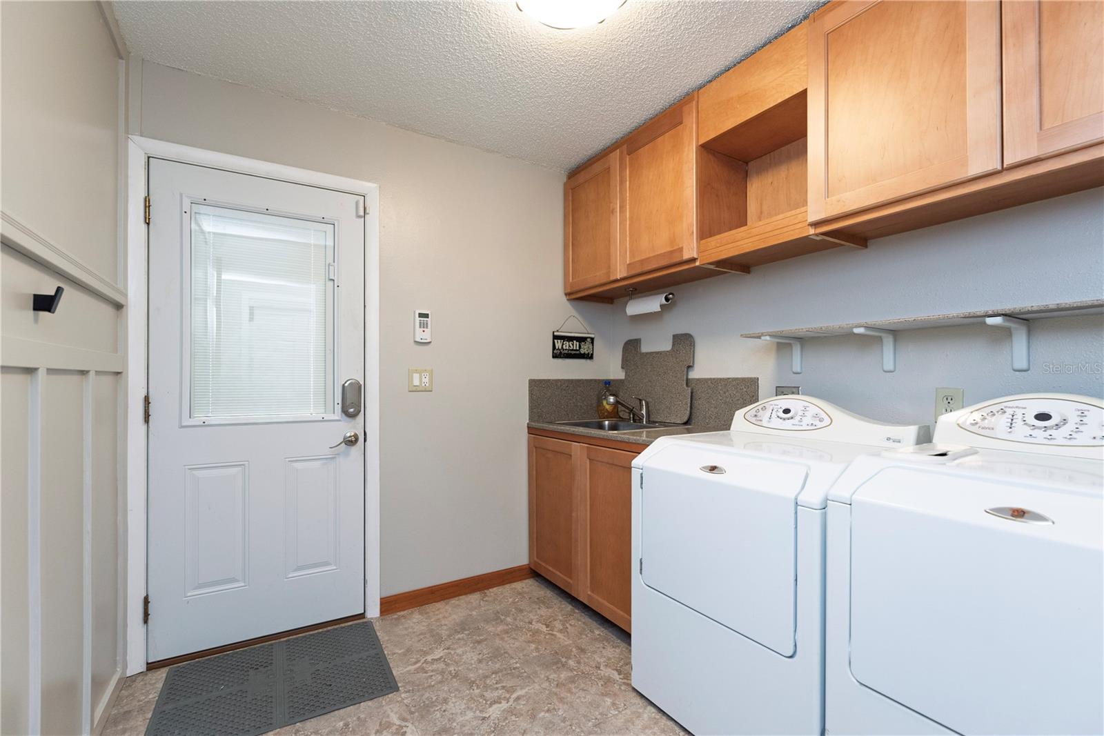 Inside laundry room with utility sink and custom details.