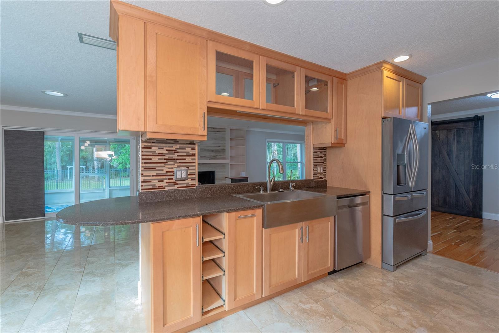 Kitchen has stainless steel appliances and solid-surface counters.