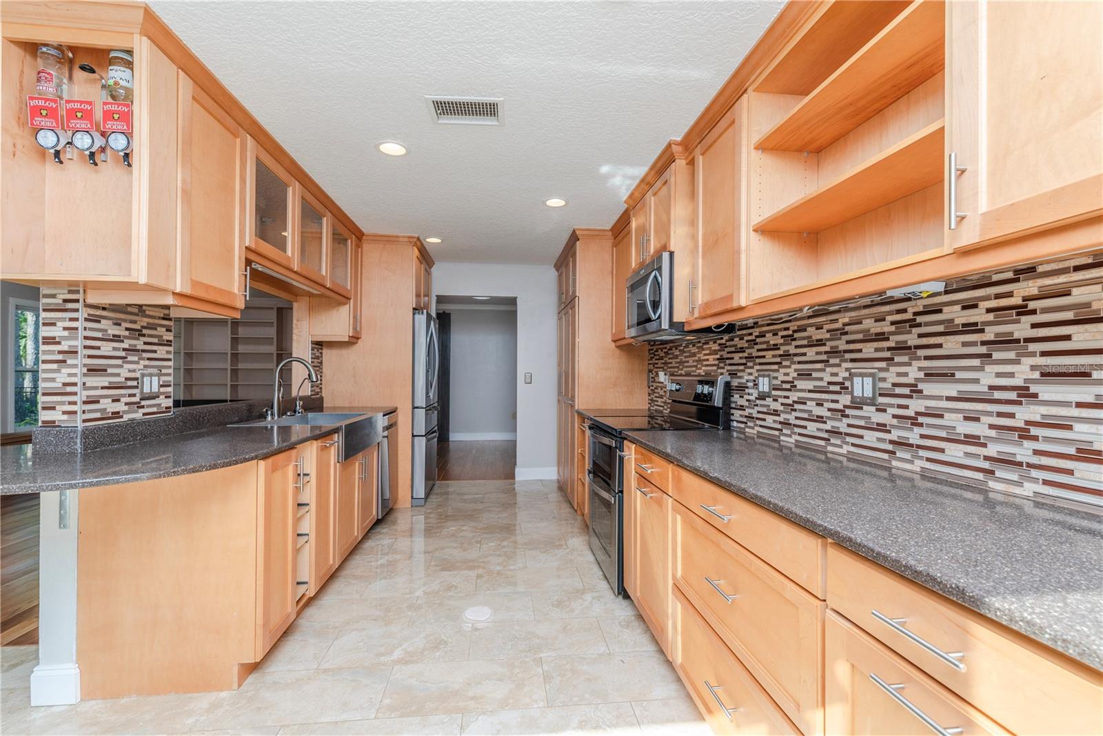 Rev-a-Shelf kitchen system with mixer valet and pull-out shelves.