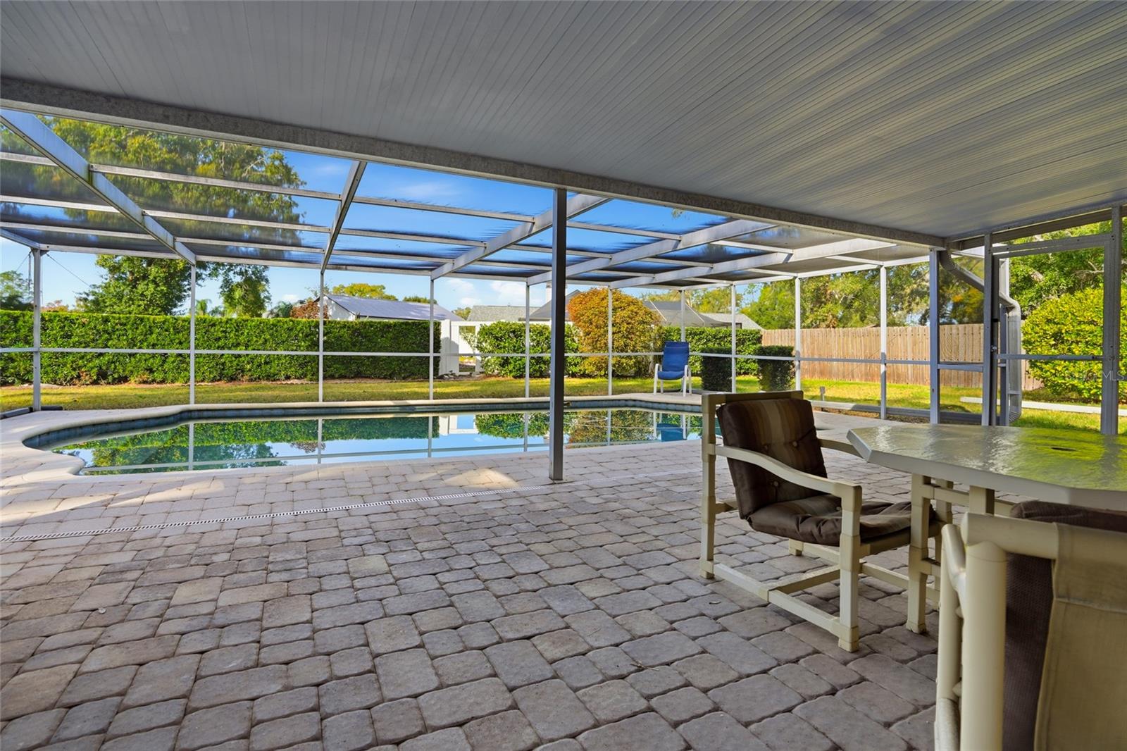 Generous covered lanai area with pavers