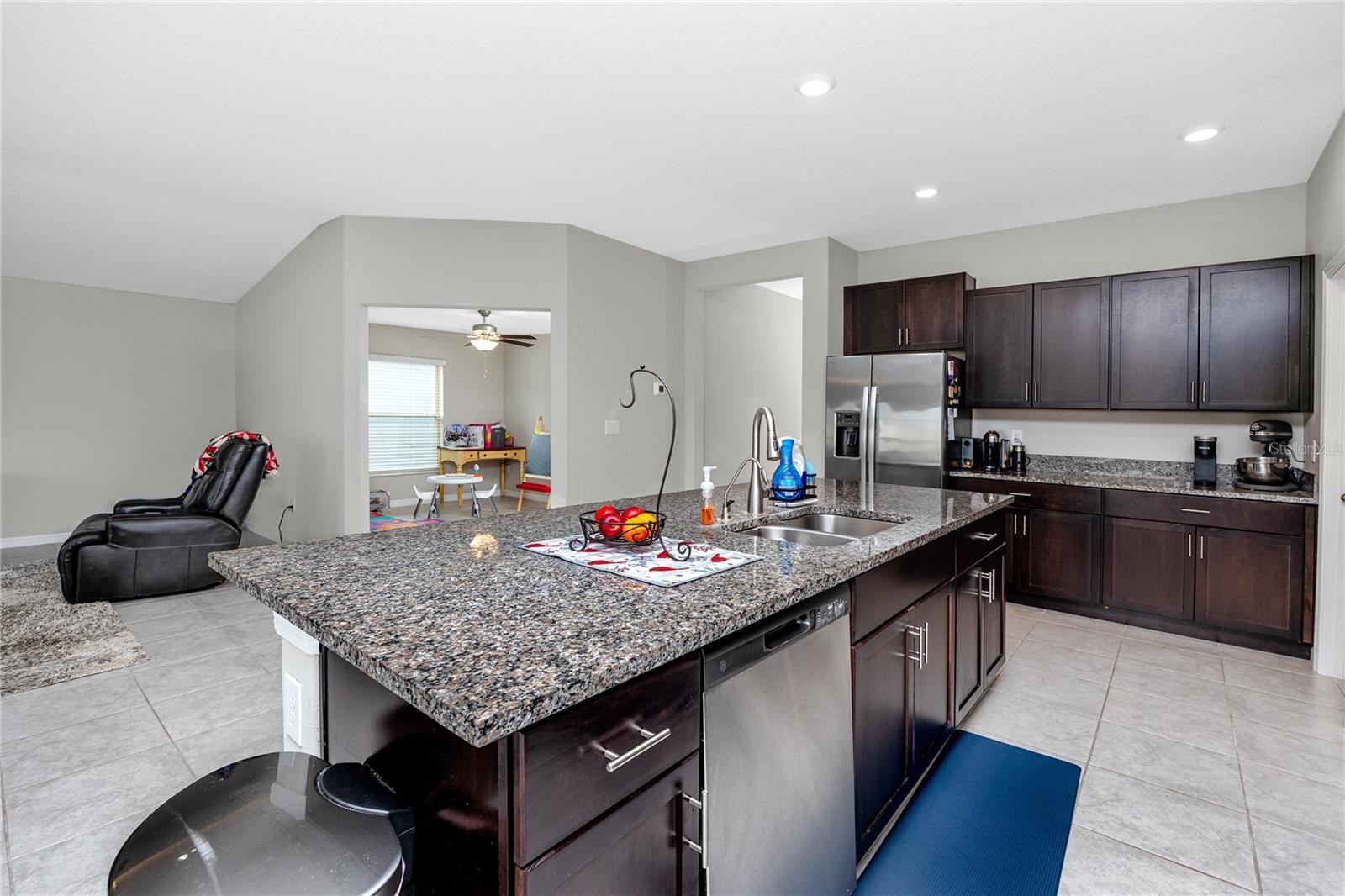 Kitchen looking in on the bonus room currently being used as a play room. Perfect office, workout, or craft/hobby space!