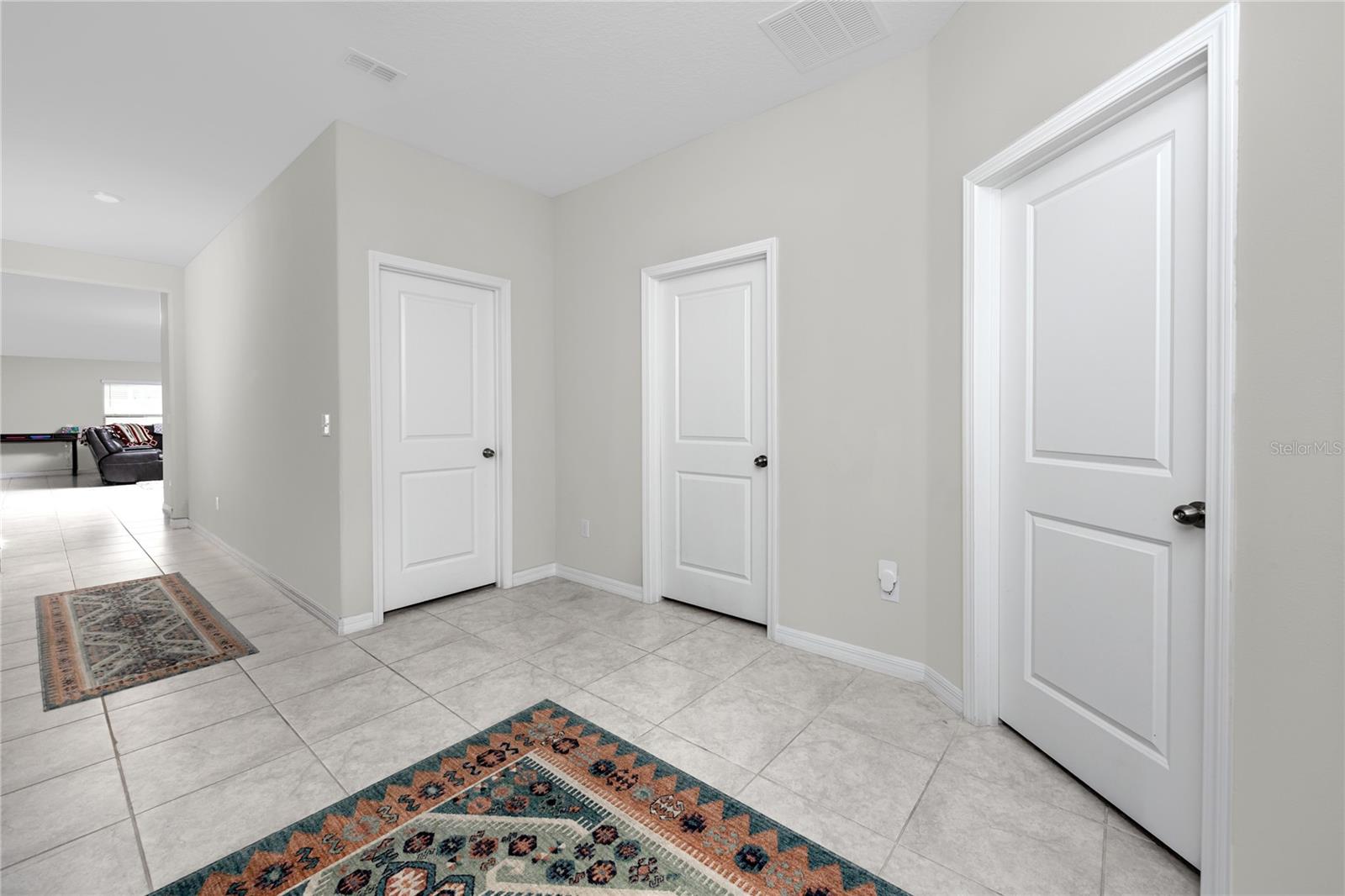 Doors to two bedrooms, with a full bath in the center at the front of the house.
