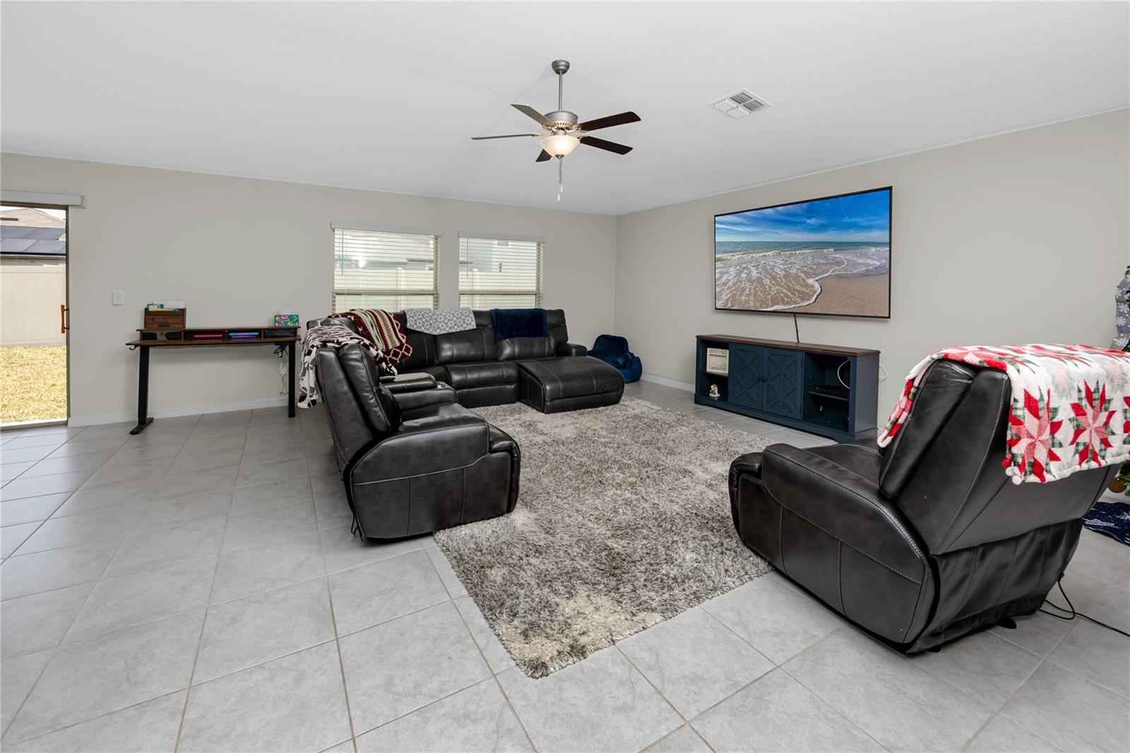 Large living room with easy care tile and lots of natural light!