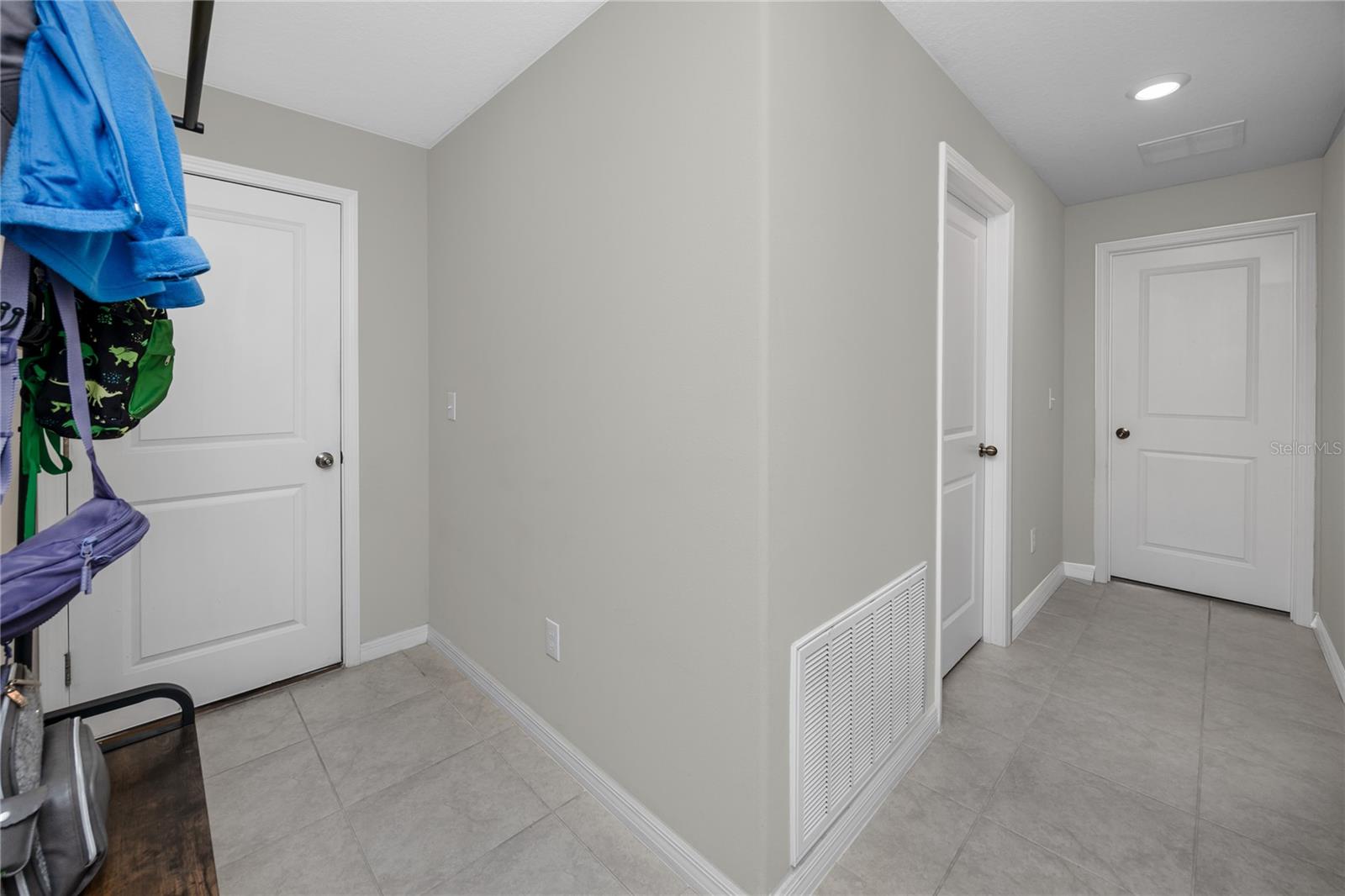 Garage entry to the left, laundry room in the center, and entrance to Jr. Suite to the right.