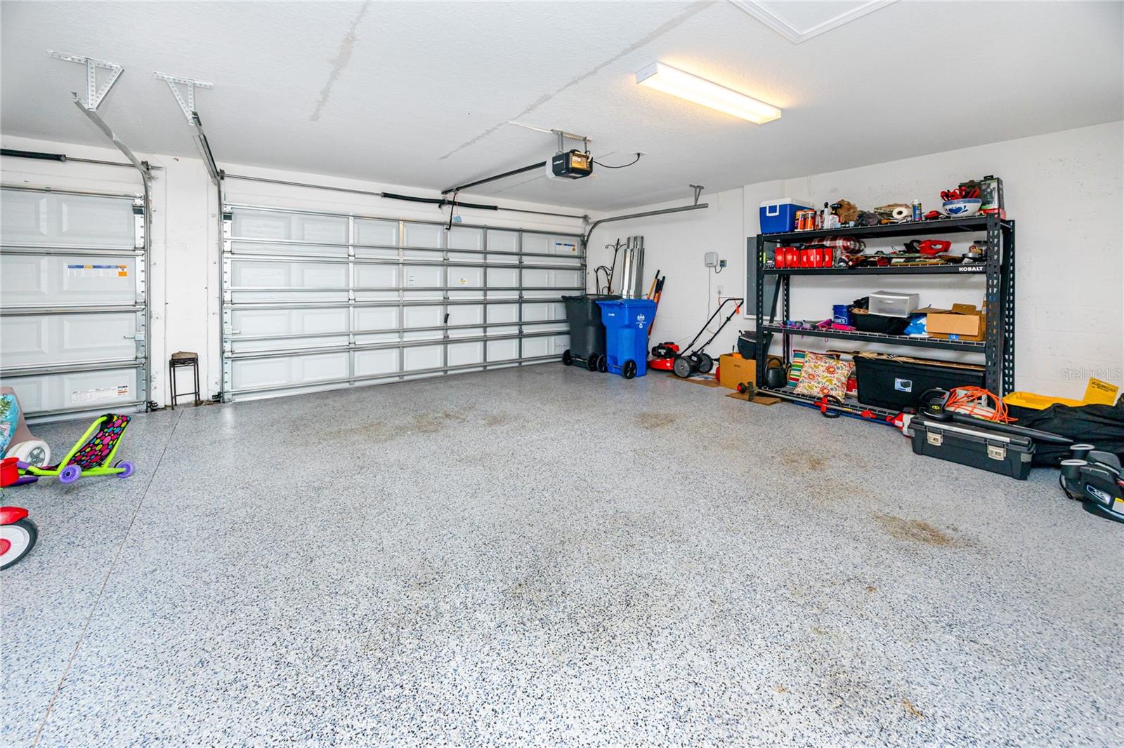 Large 3 car garage with epoxy floors to store all your toys!