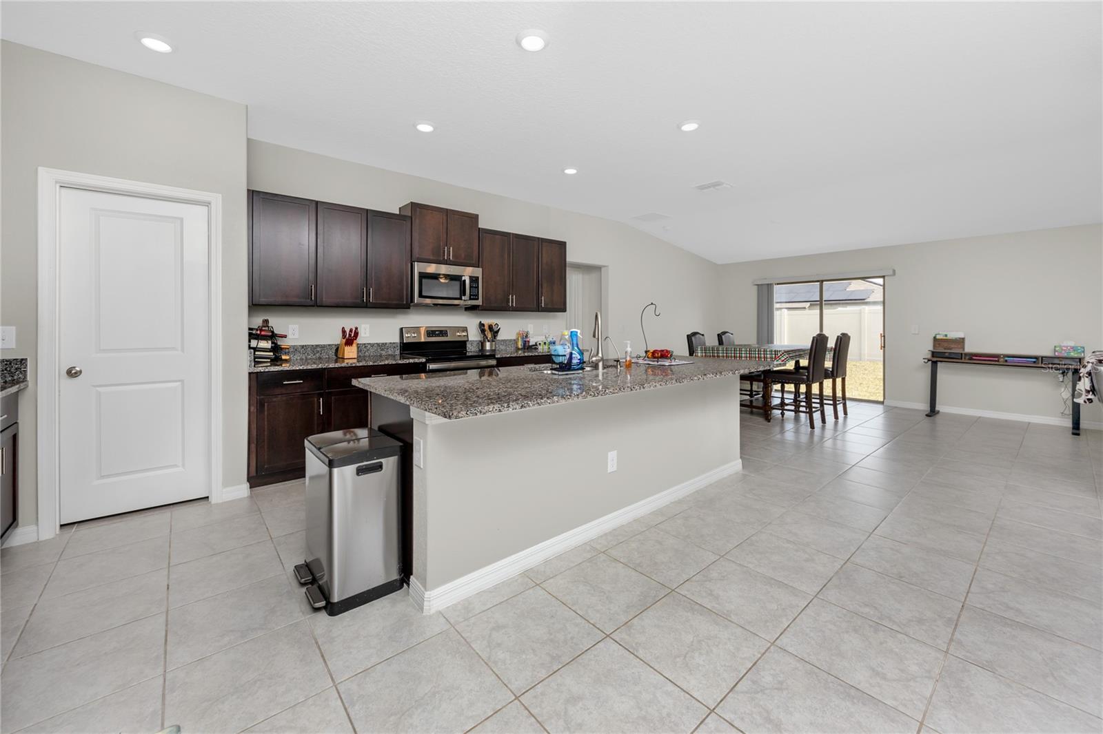 Kitchen with dining room and sliding doors out to the backyard.