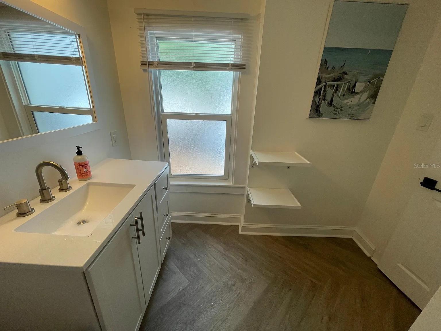 Updated flooring and vanity in bathroom