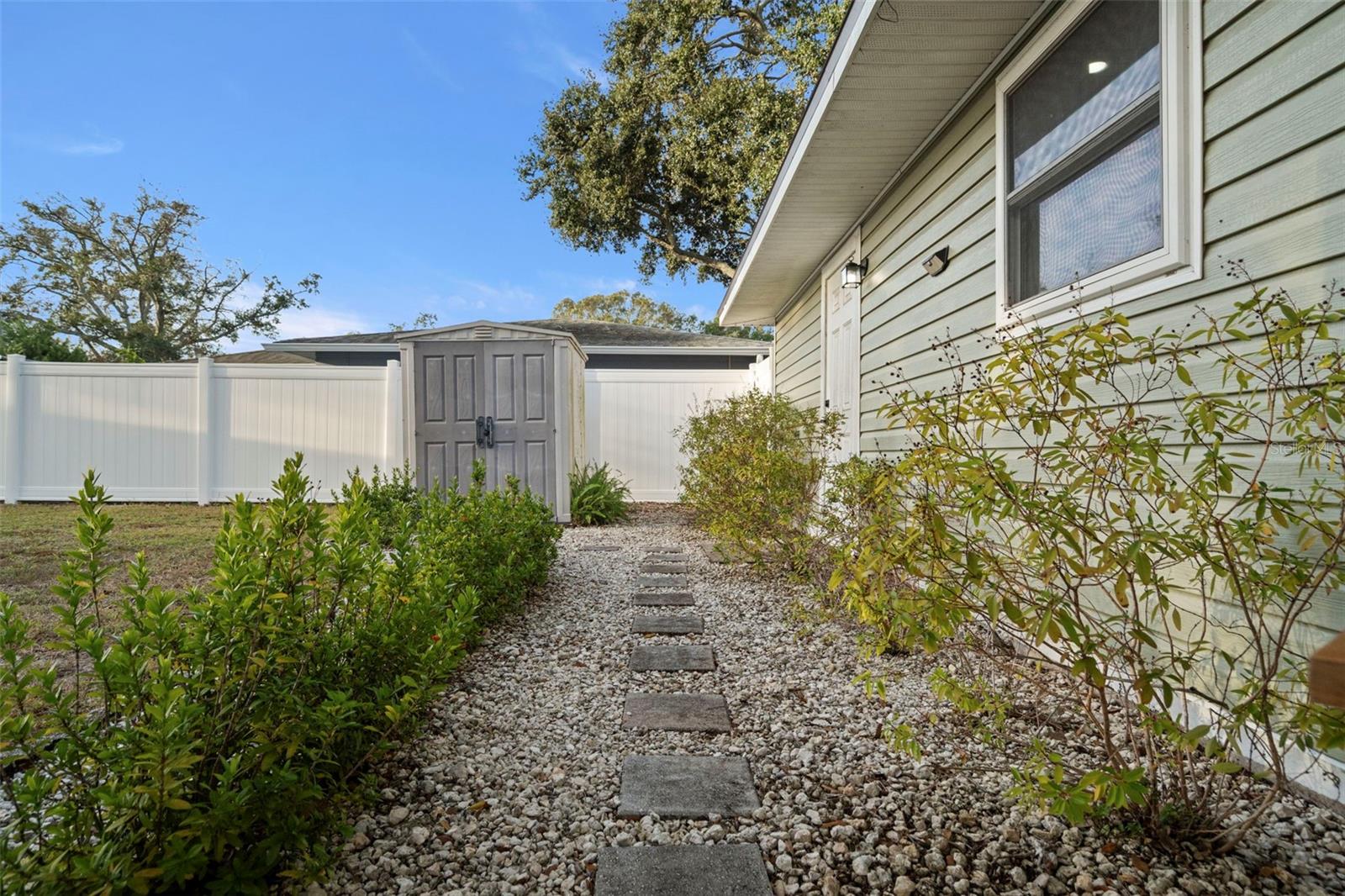 Walkway towards shed and back door access between kitchen and utility room leading to garage!