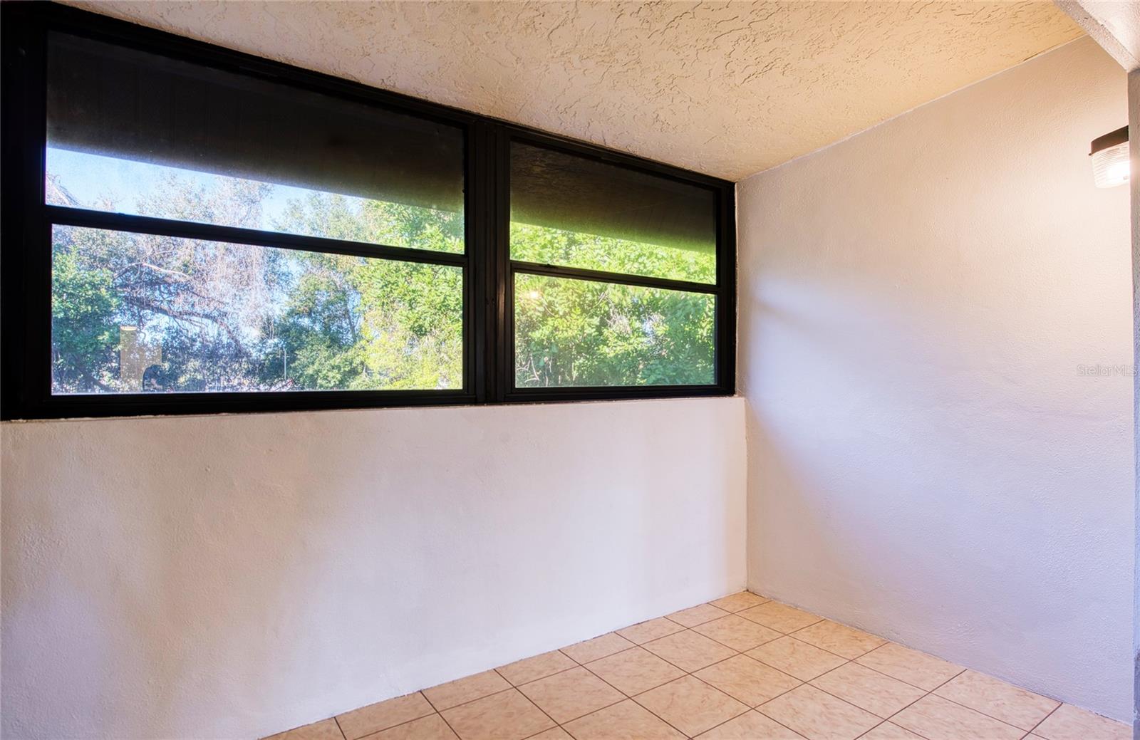 that overlooks a wooded area.