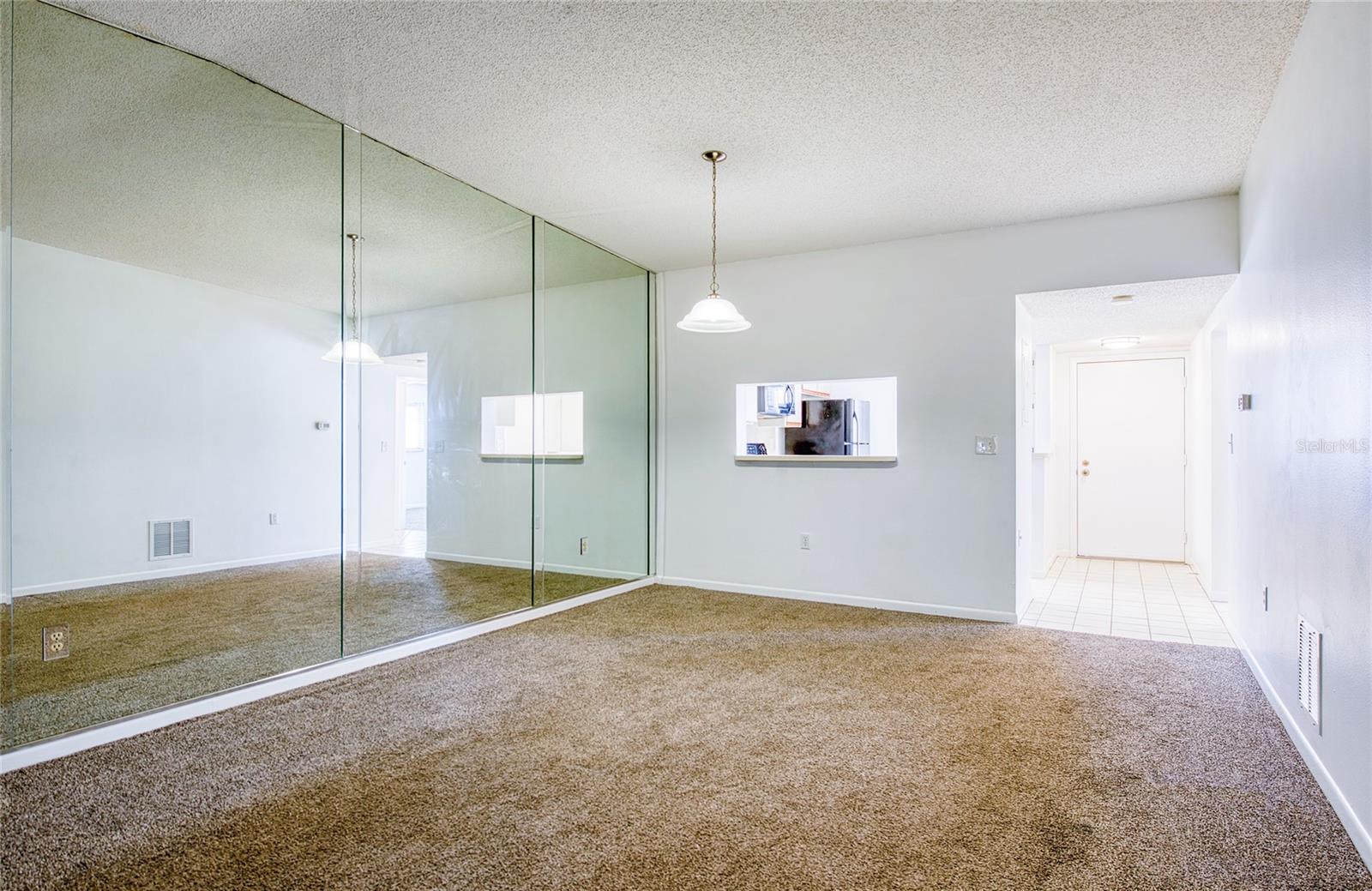 The glass mirrored wall makes a very large room seem even larger.