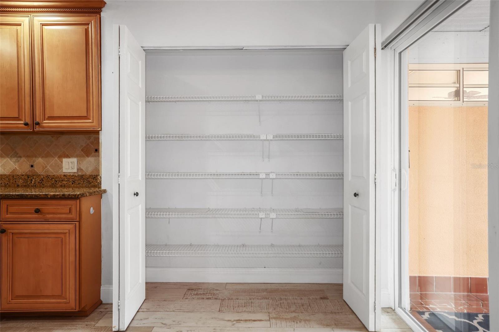 pantry with lots of shelves and folding doors