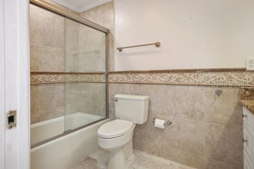 BEAUTIFULLY TILED BATH WITH GRANITE COUNTERS ON WELL APPOINTED VANITY