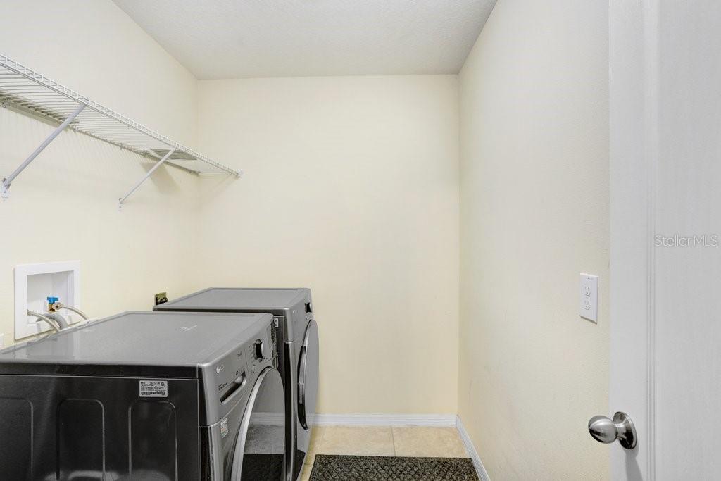 upstairs laundry room with shelving