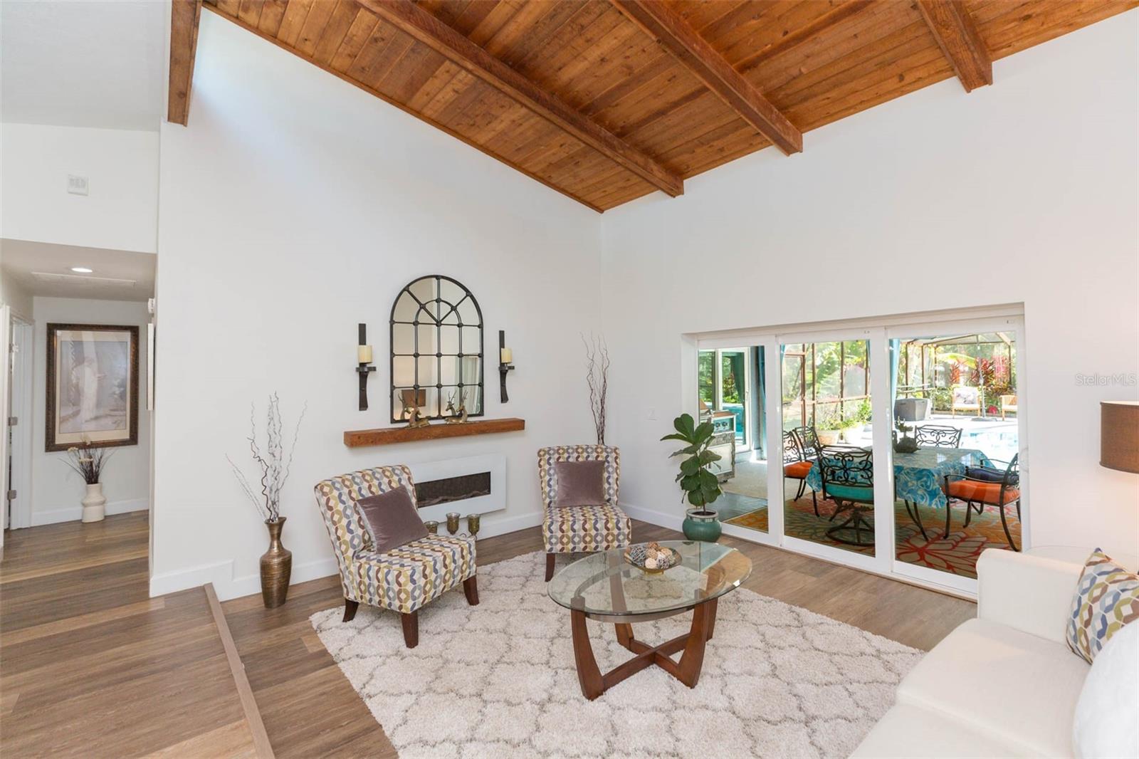 Living Room with triple sliders to pool