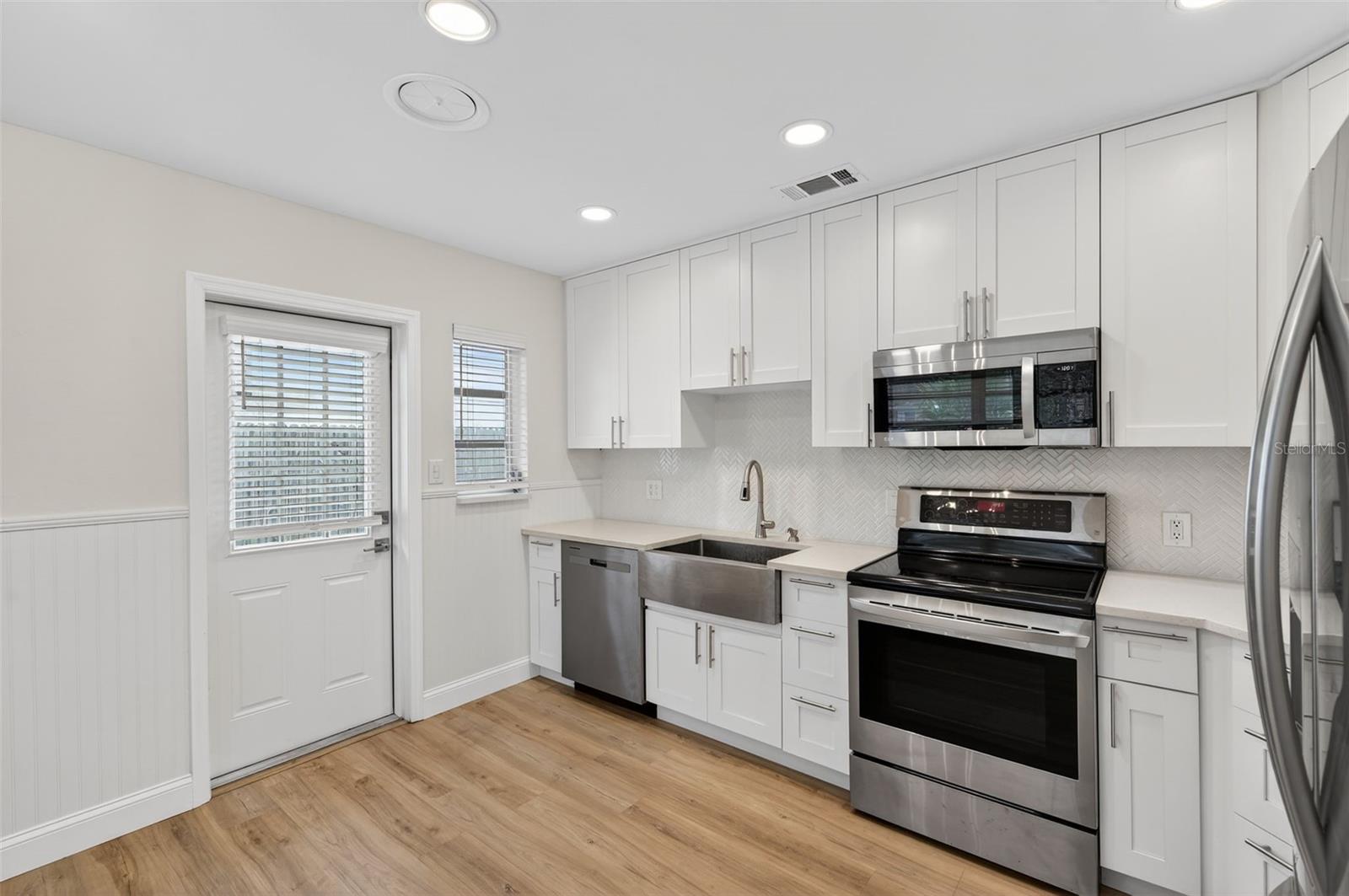 Side entrance between kitchen and dining room. Brand new kitchen with stainless steel appliances & farmhouse sink