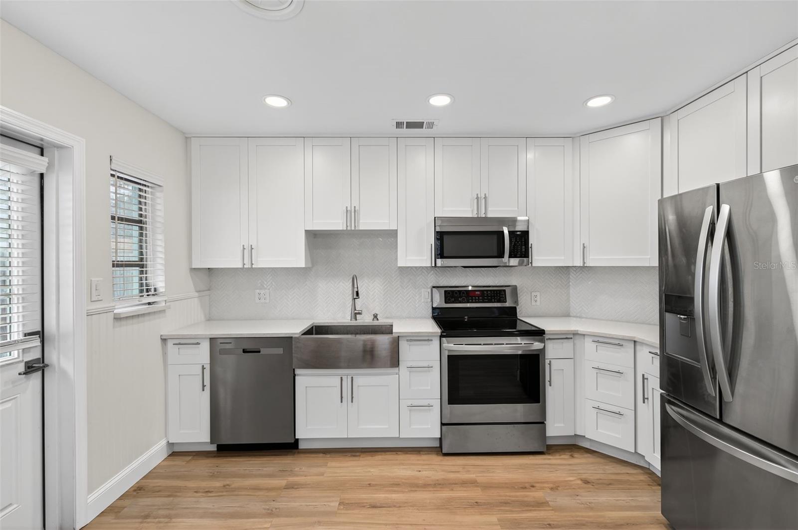 Brand new kitchen with stainless steel appliances & farmhouse sink