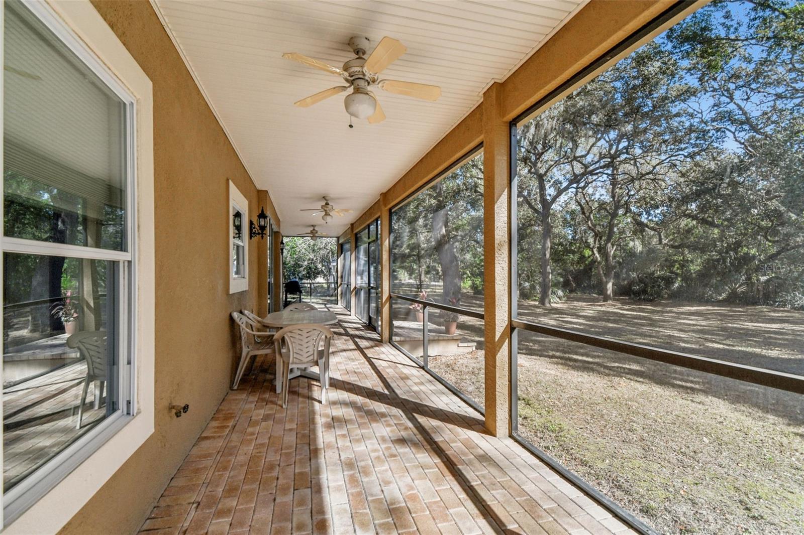 Huge screened in back porch with brick pavers and no rear neighbors