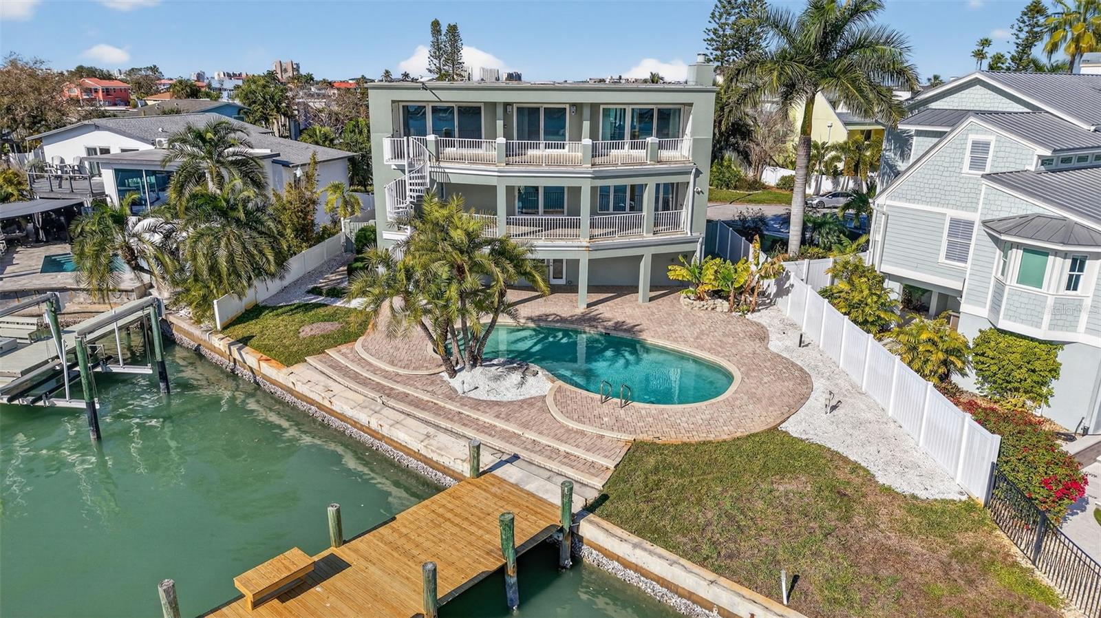Rear Elevation Highlighting Newly Reclad Dock, Pool, Paver Patio, and Expansive Porches