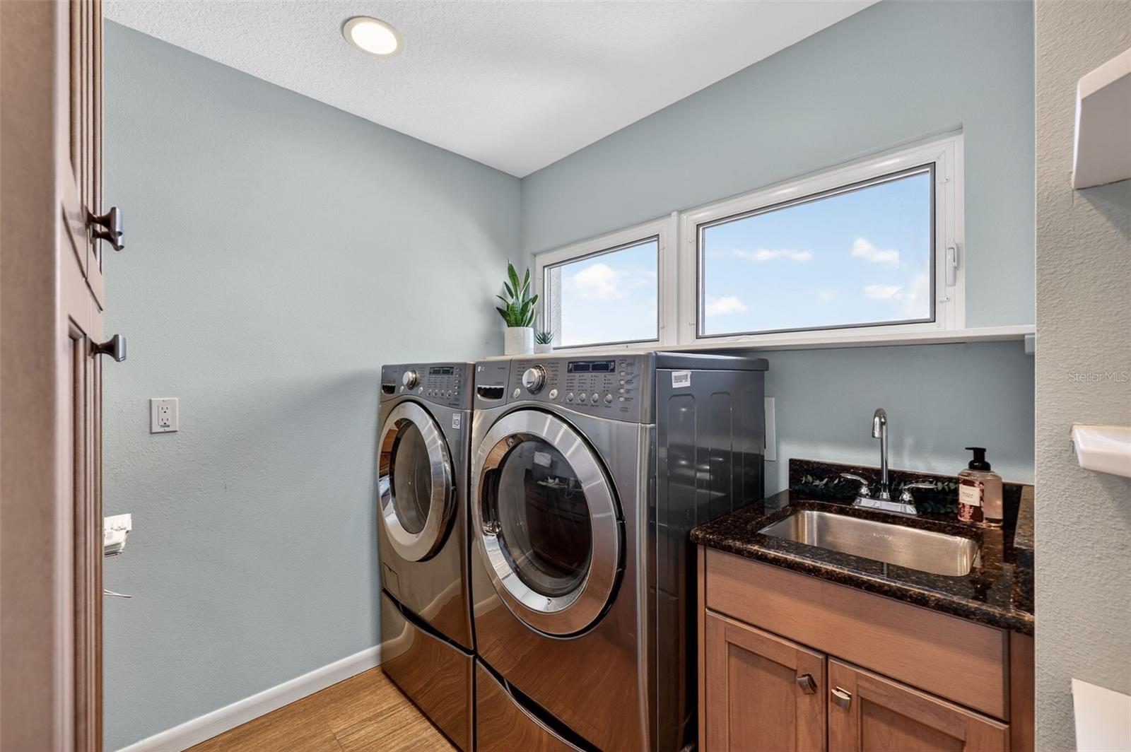 Second Floor Laundry Room with Additional Storage Opposite of Washer and Dryer