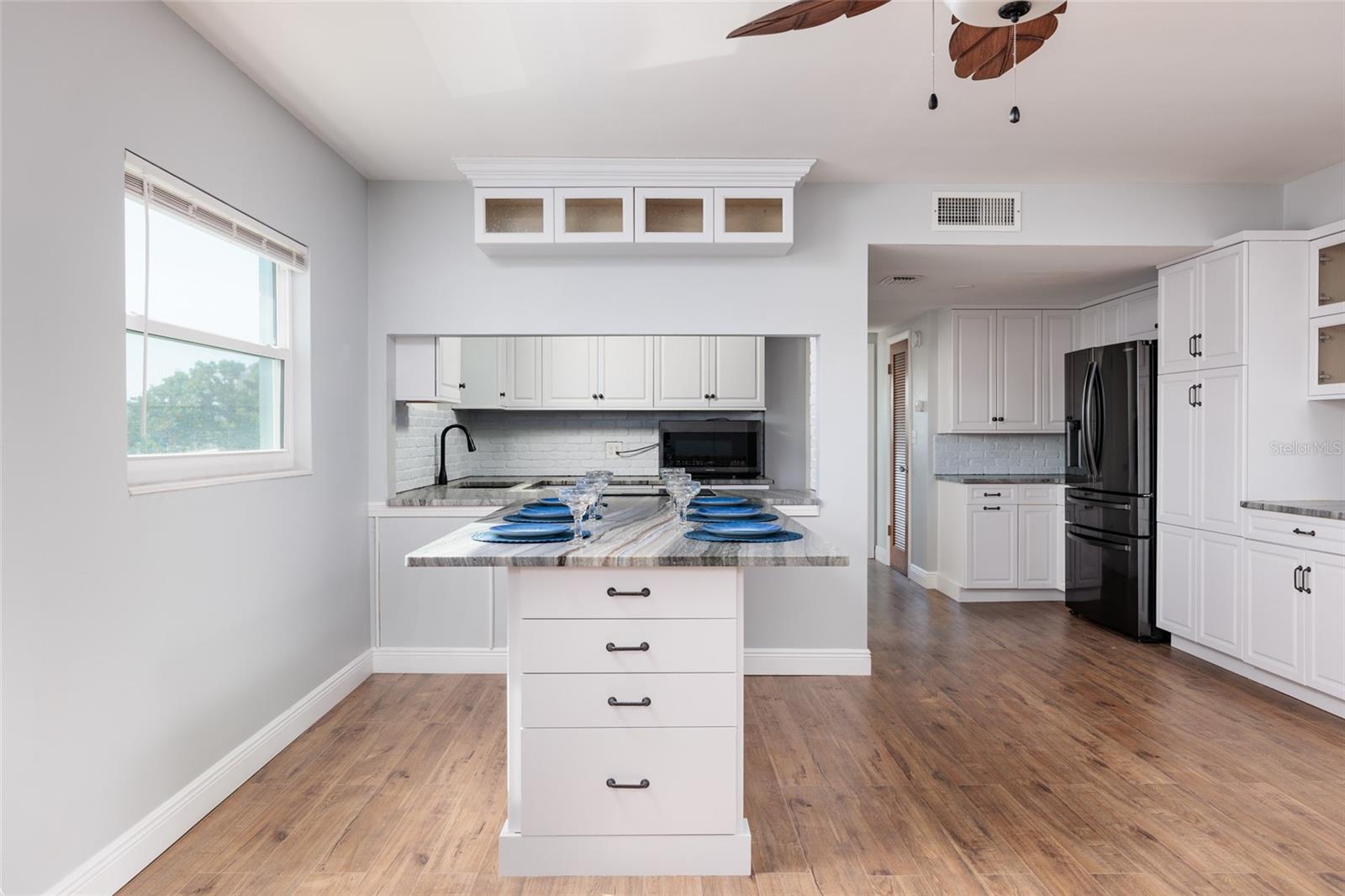 Dining area & Kitchen. Built-in granite table w/drawers & pull out shelves.