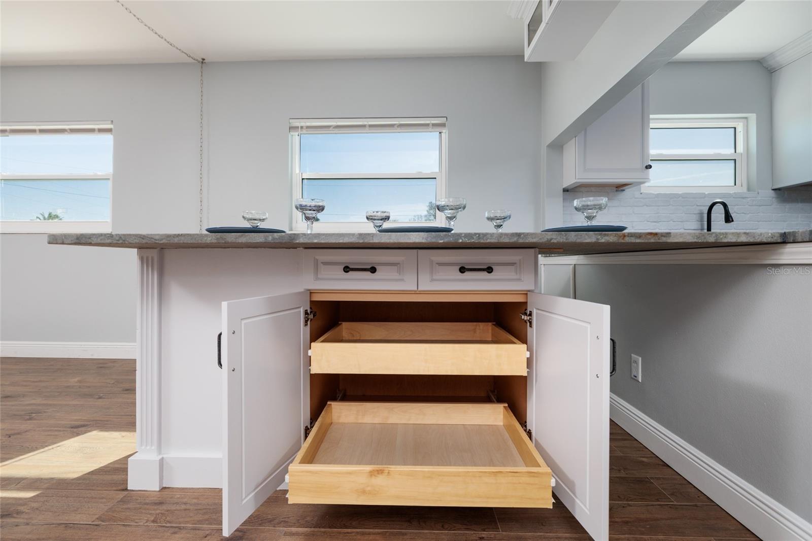 Pull out shelves below dining room granite table.