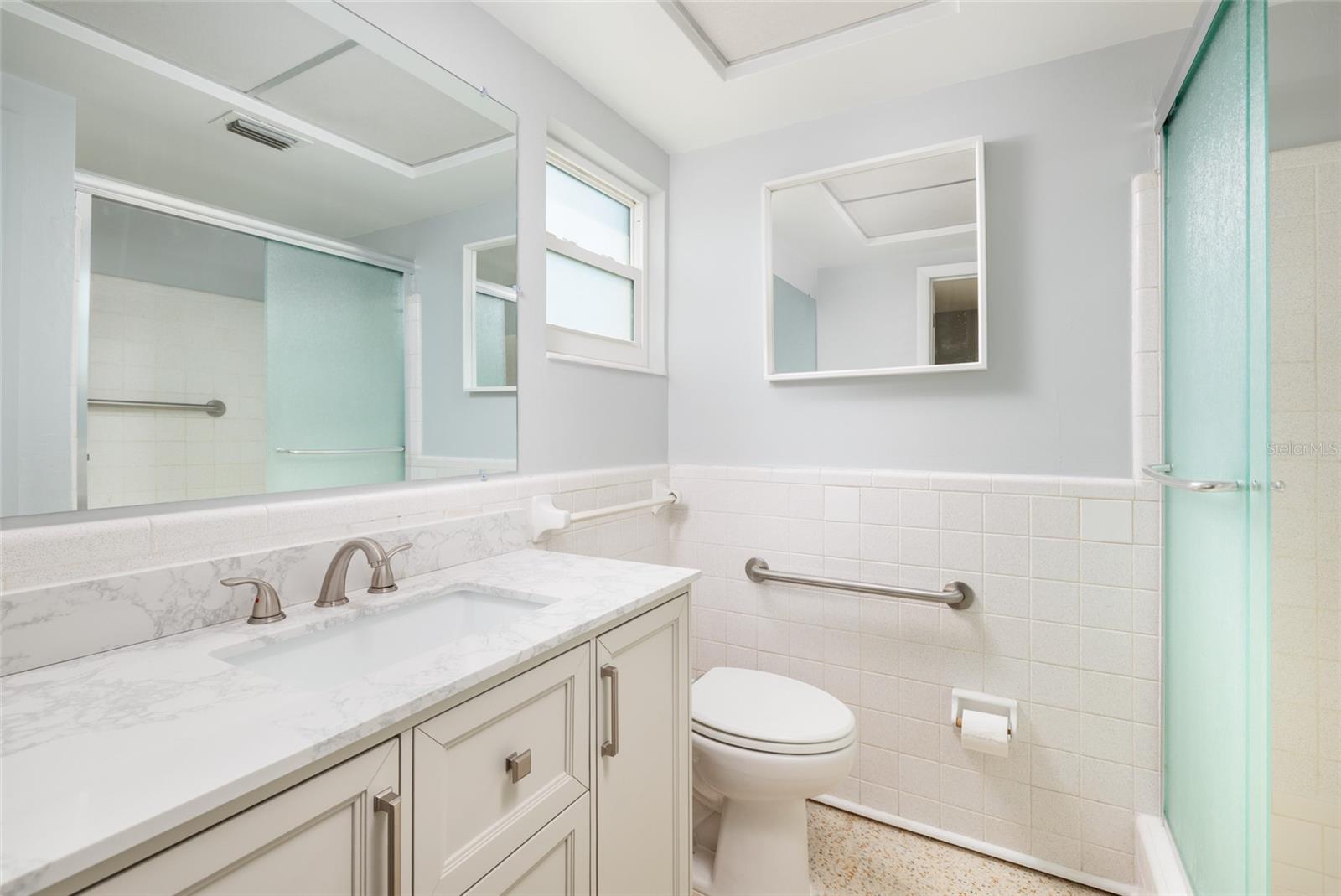 Primary bathroom w/Shower & linen closet. Granite counter. Hurricane impact double pane window.