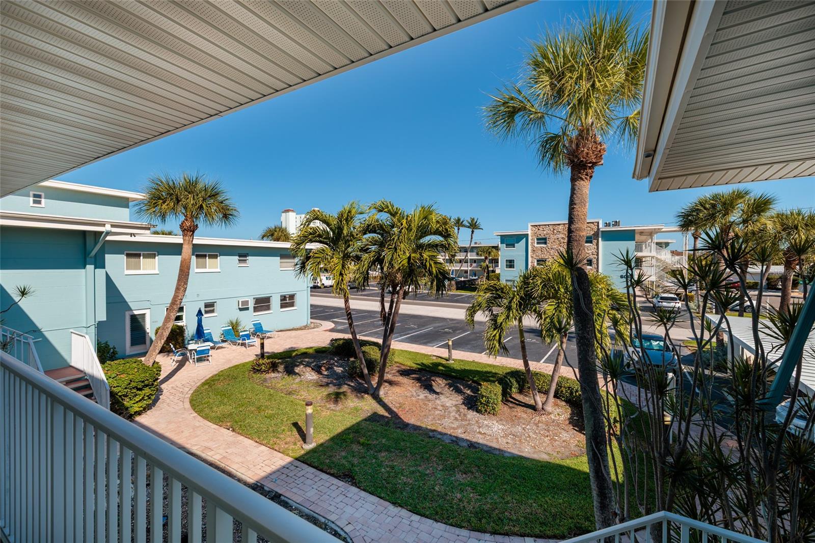 View from walkway/ porch outside of front door. Laundry/storage room is downstairs & straight down the walkway.
