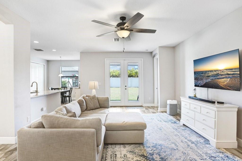 Open Living Area with view to back yard.  Beautiful wood plank tiles adorn the floors
