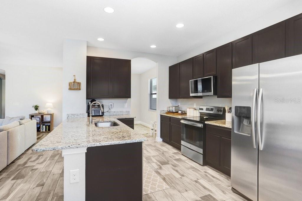 Kitchen with beautiful kitchen cabinets, granite and stainless Steel appliances.