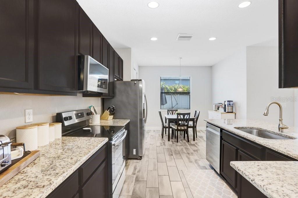 Kitchen with beautiful kitchen cabinets, granite and stainless Steel appliances.
