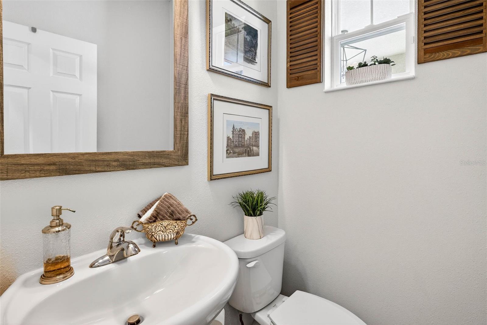 Half bath for guests conveniently located downstairs.