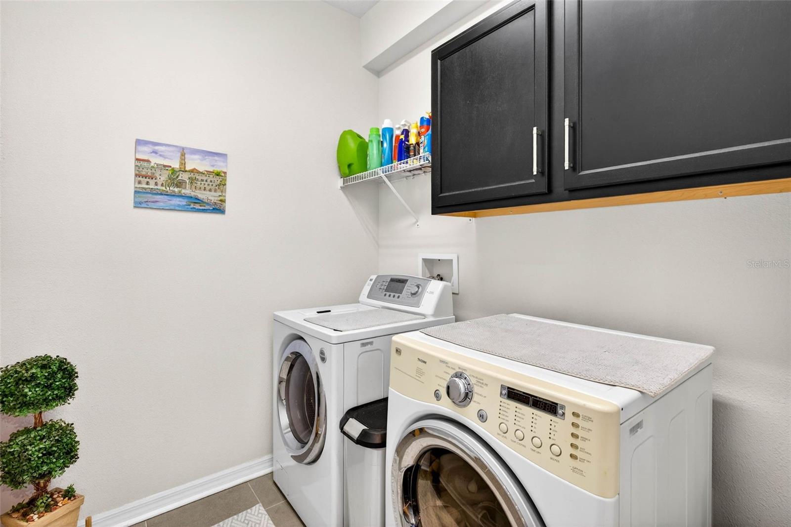 Laundry room complete with cabinetry. Washer and dryer do convey.
