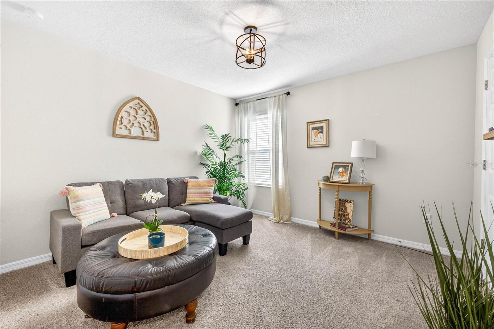 Secondary bedroom serving as a private sitting area. Bedroom has a built in closet and natural lighting.