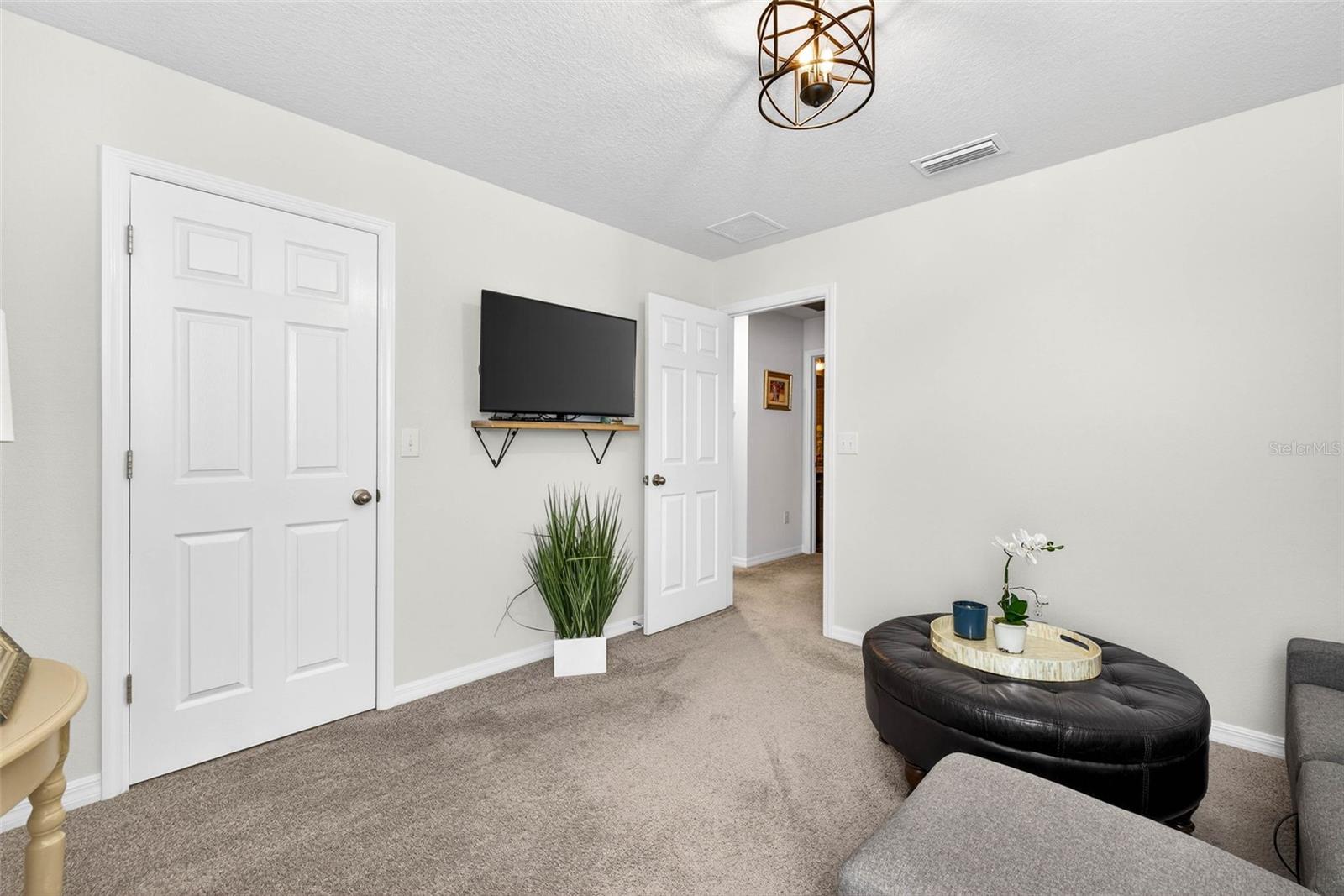 Secondary bedroom serving as sitting area has built in closet.