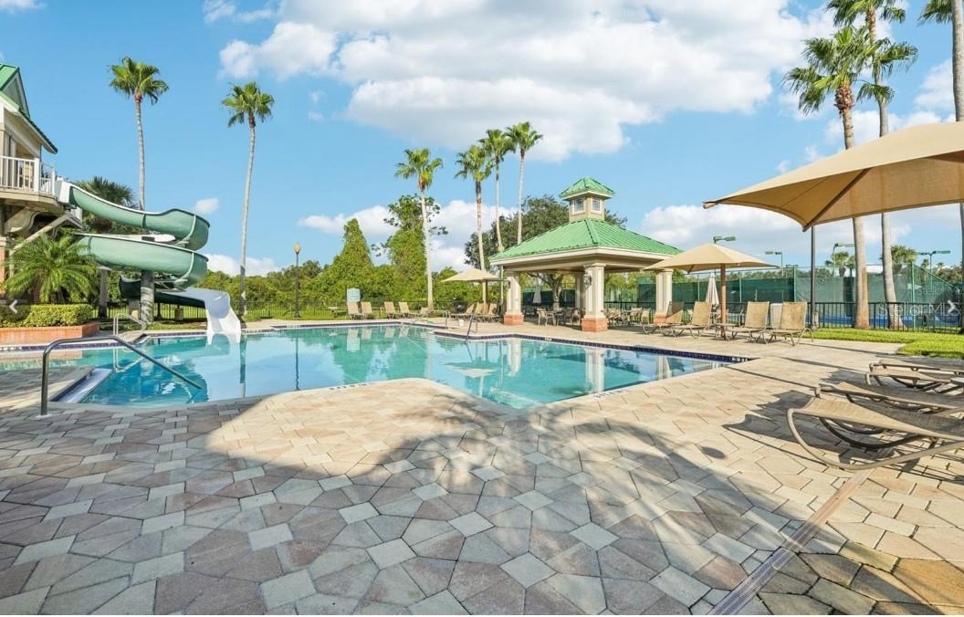 Community pool area with water slide and cabana.