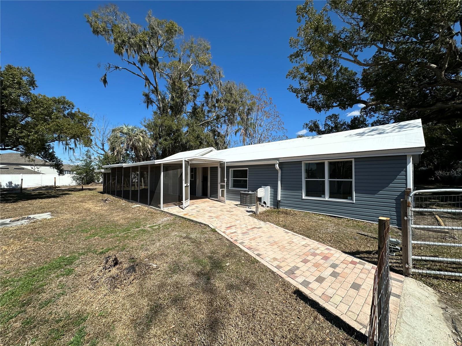 Paver walkway and large screened patio